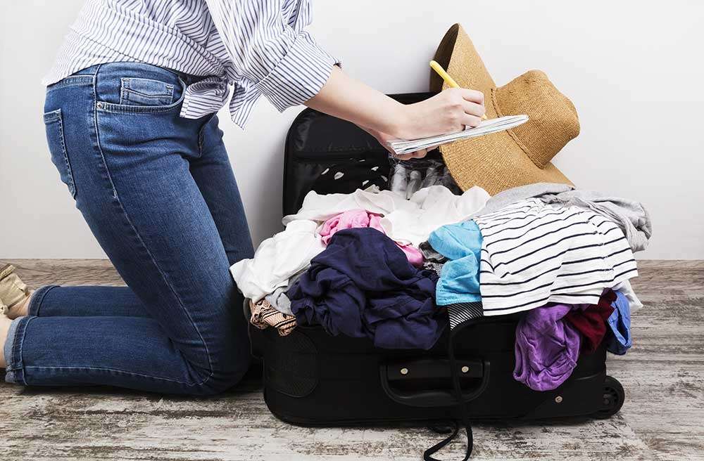 girl-casually-packs-suitcase