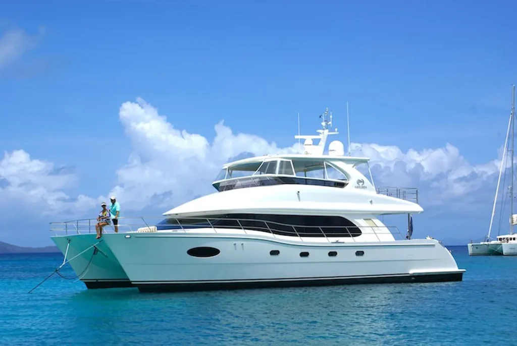 Catamaran Charters yacht anchored on Caribbean waters at sunset.