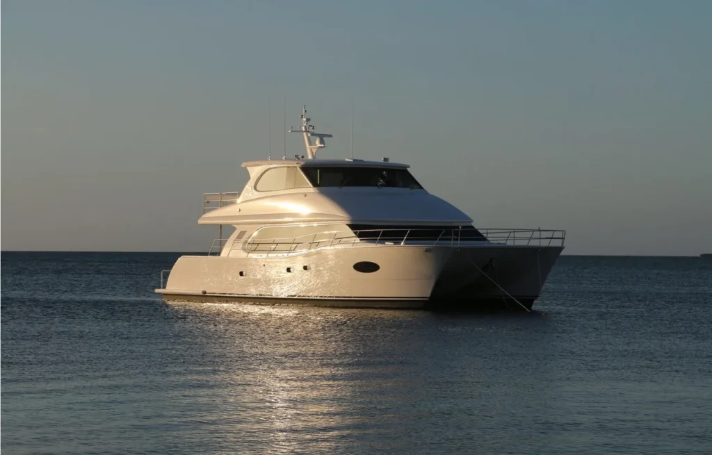 A power cat anchored in turquoise Caribbean water beneath a bright blue sky.